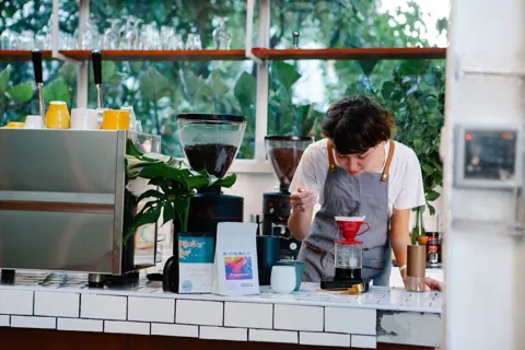 Barista making fresh coffee